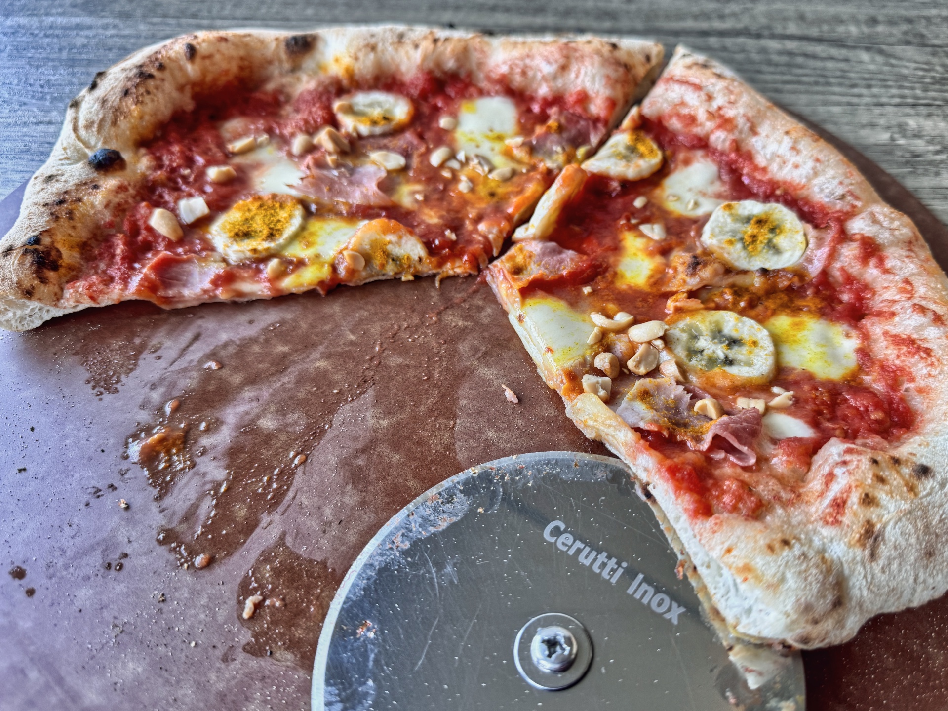 Bananenpizza Pizza Africana auf dem Schneidebrett