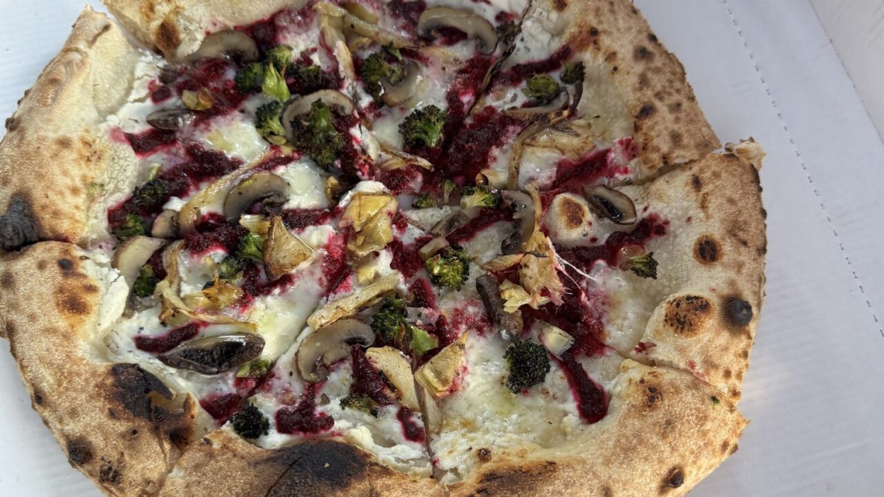 Vegetarische Pizza mit Rote-Rüben-Creme, Brokkoli, Artischocken und Champignons auf weißer Ricotta-Sauce